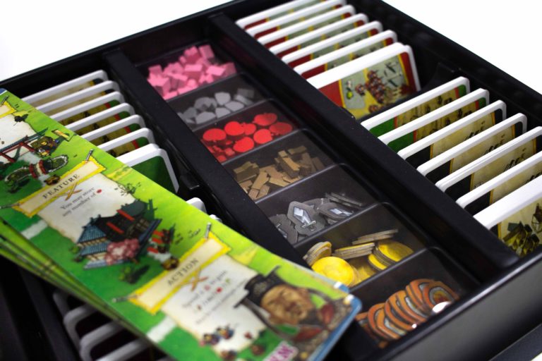 The lidded token tray is hidden under the playerboards.